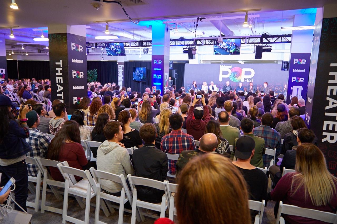 An audience seated for a program in the Exhibit Hall